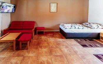 Dvoulůžkový pokoj Deluxe s manželskou postelí v budově restaurace